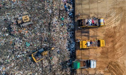 Waste being disposed of by diggers in the disposal pits.