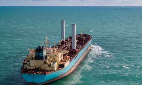 A large boat carrying containers on the sea.