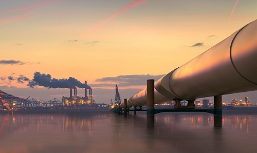 pipeline with factories at dusk