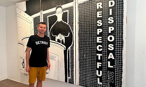 Mark standing in front of one of his paintings