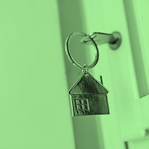 A house-shaped key in a key hole